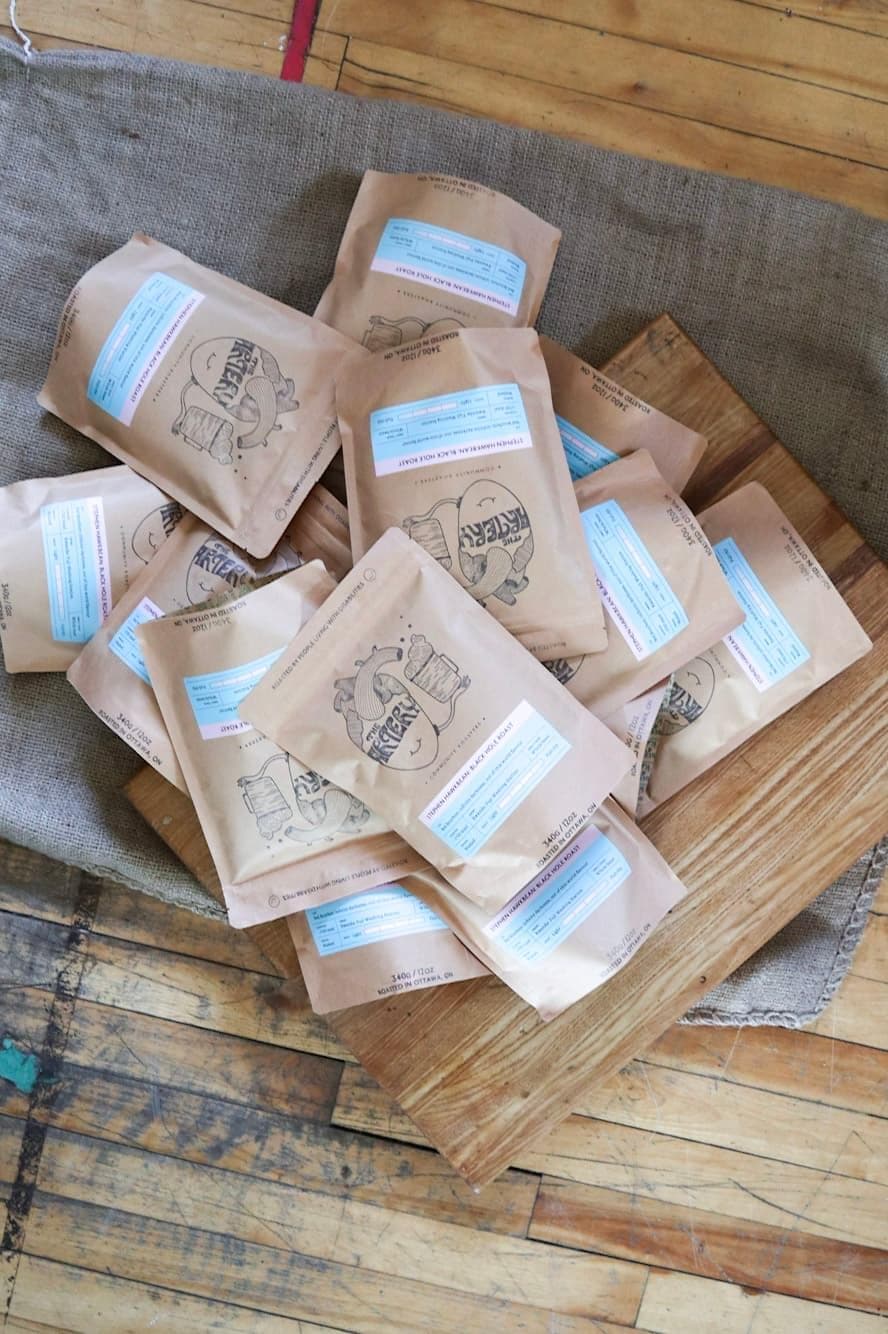 A pile of coffee bags from The Artery Community Roasters.